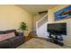 Comfortable living room features plush furniture and staircase access at 3909 45Th W Ter # 102, Bradenton, FL 34210