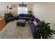 Spacious living room with comfortable gray seating, soft carpet, and natural light streaming through the large window at 3909 45Th W Ter # 102, Bradenton, FL 34210
