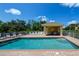 Sparkling community pool area with comfortable lounge chairs, and a covered dining space at 3909 45Th W Ter # 102, Bradenton, FL 34210