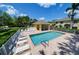 Community pool features a paver deck, lounge chairs, a covered dining area, and secure fencing at 3909 45Th W Ter # 102, Bradenton, FL 34210