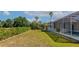 Large backyard with an ample green space, a screened-in patio, and a pool at 4092 Green Tree Ave, Sarasota, FL 34233