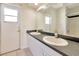 Bright bathroom features a large mirror, double sink, and walk-in shower at 4092 Green Tree Ave, Sarasota, FL 34233