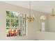 Bright dining room featuring a chandelier and large window showcasing a lush outdoor view at 4092 Green Tree Ave, Sarasota, FL 34233