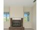 Living room featuring a brick fireplace and mantle with bright windows at 4092 Green Tree Ave, Sarasota, FL 34233