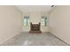 Empty living room featuring a brick fireplace and bright windows at 4092 Green Tree Ave, Sarasota, FL 34233