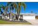 Charming single Gathering home featuring a two-car garage, lush landscaping, and curb appeal at 4092 Green Tree Ave, Sarasota, FL 34233