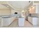 Bright kitchen featuring a center island, white cabinets, and stainless steel appliances at 4092 Green Tree Ave, Sarasota, FL 34233