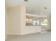 Open concept kitchen and living area with white cabinets, counter seating and large window at 4092 Green Tree Ave, Sarasota, FL 34233