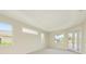 Spacious bedroom with tray ceiling, bright windows, and French doors at 4092 Green Tree Ave, Sarasota, FL 34233