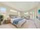 Relaxing bedroom with tray ceiling, large bed, and French doors leading to the pool at 4092 Green Tree Ave, Sarasota, FL 34233