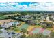 Community aerial view showcasing swimming pool, tennis and basketball courts, and lush landscaping at 4513 Abacos Pl, Bradenton, FL 34203