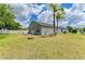 Expansive backyard showcasing a lush lawn, fire pit, and the home's exterior at 4513 Abacos Pl, Bradenton, FL 34203