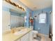 This bright bathroom features a white vanity, tile floor, and a shower with curtain at 4513 Abacos Pl, Bradenton, FL 34203