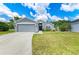 Attractive single-story home with a two-car garage, lush lawn, and inviting front entrance with decorative touches at 4513 Abacos Pl, Bradenton, FL 34203