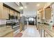 Bright kitchen featuring stainless steel appliances and tiled floors at 4513 Abacos Pl, Bradenton, FL 34203