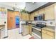 Galley kitchen featuring stainless steel appliances and a view of the bedroom at 4513 Abacos Pl, Bradenton, FL 34203