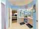 Bright bathroom features double sinks, large mirrors, and an open doorway to main bedroom at 4513 Abacos Pl, Bradenton, FL 34203