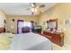 This main bedroom boasts a ceiling fan, a window with curtains, and classic wood furniture at 4513 Abacos Pl, Bradenton, FL 34203