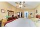 Cozy main bedroom features a ceiling fan, wood furniture, and access to an ensuite bathroom at 4513 Abacos Pl, Bradenton, FL 34203