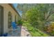Inviting backyard with a stone patio, lush landscaping, and shaded seating area at 4691 Las Brisas Ln, Sarasota, FL 34238