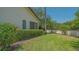 Well manicured backyard with lush lawn and garden area at 4691 Las Brisas Ln, Sarasota, FL 34238