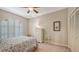Cozy bedroom with a patterned bedspread, arched shuttered window, and comfortable decor at 4691 Las Brisas Ln, Sarasota, FL 34238