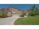 Charming home with a well-maintained lawn, red tile roof, and attached two car garage at 4691 Las Brisas Ln, Sarasota, FL 34238