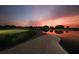 Golf course and pond at sunset with pink sky at 4691 Las Brisas Ln, Sarasota, FL 34238