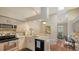 Kitchen with stainless steel appliances, granite counters, and an open dining area at 4691 Las Brisas Ln, Sarasota, FL 34238