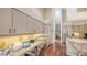 Home office and kitchen space with granite counters, wood floors, and ample storage at 4691 Las Brisas Ln, Sarasota, FL 34238