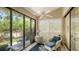 Relaxing sunroom with tile floor, ceiling fan, and sliding glass doors to backyard at 4691 Las Brisas Ln, Sarasota, FL 34238