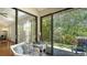 Bright sunroom featuring tile floors, white furniture, and sliding glass doors at 4691 Las Brisas Ln, Sarasota, FL 34238