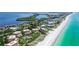 Breathtaking aerial view of beachside condos along the shoreline, showcasing the beautiful coastal community at 4800 Gulf Of Mexico Dr # 205, Longboat Key, FL 34228