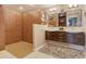 Bright bathroom boasts double sinks, wood cabinets, mirrors, and lots of closet space, creating an organized space at 4800 Gulf Of Mexico Dr # 205, Longboat Key, FL 34228