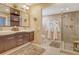Neutral bathroom features double sinks, a walk-in shower, fluffy rug, and plenty of space to relax at 4800 Gulf Of Mexico Dr # 205, Longboat Key, FL 34228