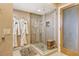 Clean bathroom featuring a glass shower with robes hanging nearby for convenience after a shower at 4800 Gulf Of Mexico Dr # 205, Longboat Key, FL 34228