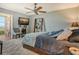 Stylishly decorated bedroom with a comfortable bed, TV, and a view of the water at 4800 Gulf Of Mexico Dr # 205, Longboat Key, FL 34228