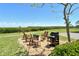 Community grilling area with seating, perfect for outdoor cooking and entertaining at 4800 Gulf Of Mexico Dr # 205, Longboat Key, FL 34228
