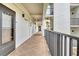 Exterior condo hallway with an exit sign, neutral paint color, and a black iron railing at 4800 Gulf Of Mexico Dr # 205, Longboat Key, FL 34228