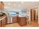 A kitchen with a large breakfast bar opens to living area with ocean views in this well designed home at 4800 Gulf Of Mexico Dr # 205, Longboat Key, FL 34228