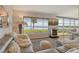 Bright living room featuring a water view, comfortable seating, and modern décor at 4800 Gulf Of Mexico Dr # 205, Longboat Key, FL 34228