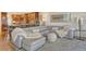 Contemporary living area featuring sleek gray furniture, plush textures, and adjacent eat-in kitchen, ideal for relaxation at 4800 Gulf Of Mexico Dr # 205, Longboat Key, FL 34228