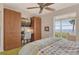 This bedroom features built-in storage, a workspace, and a stunning water view at 4800 Gulf Of Mexico Dr # 205, Longboat Key, FL 34228