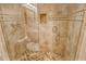 Glass walk-in shower with tile surround, convenient shelf, and a handheld shower head at 4800 Gulf Of Mexico Dr # 205, Longboat Key, FL 34228
