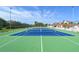 Wide shot of an outdoor tennis court with well-maintained green and blue surfaces at 4800 Gulf Of Mexico Dr # 205, Longboat Key, FL 34228