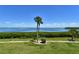 Scenic view of the water from the lawn with manicured landscaping, perfect for enjoying the outdoors at 4800 Gulf Of Mexico Dr # 205, Longboat Key, FL 34228