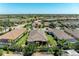 Aerial view of a home with a private backyard, lush landscaping, and surrounding neighborhood at 4908 Tivoli Run, Bradenton, FL 34211