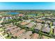 Aerial view of a beautiful lakeside community featuring a clubhouse, golf course, and scenic walking paths at 4908 Tivoli Run, Bradenton, FL 34211
