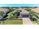 An eye-level aerial view of this single-Gathering home with an attached two car garage and a beautiful paver driveway at 4908 Tivoli Run, Bradenton, FL 34211