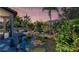 Lush backyard featuring a serene koi pond surrounded by vibrant plants and palm trees at 4908 Tivoli Run, Bradenton, FL 34211